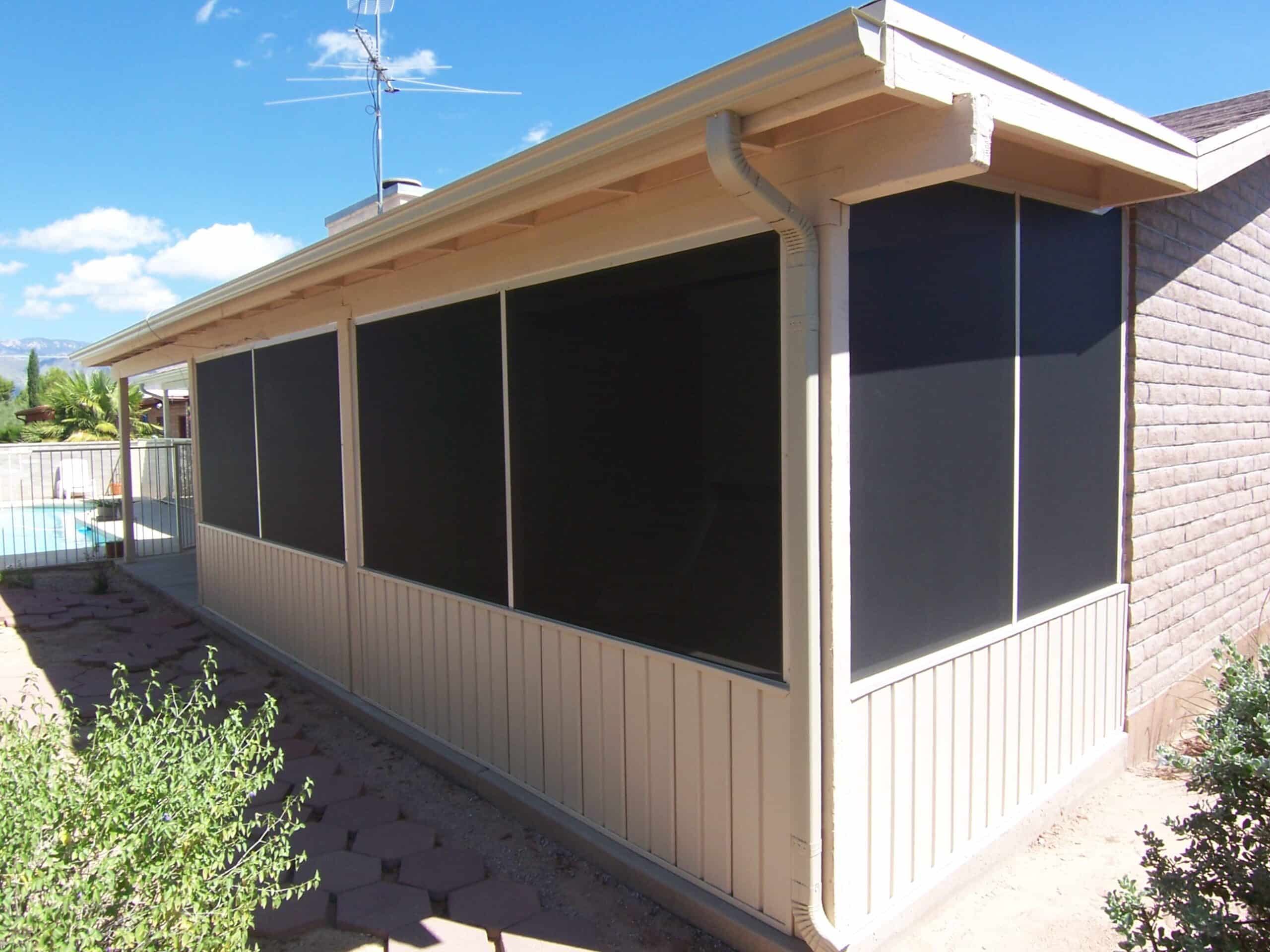 White aluminum-framed enclosure attached to the side of a Tucson, AZ home