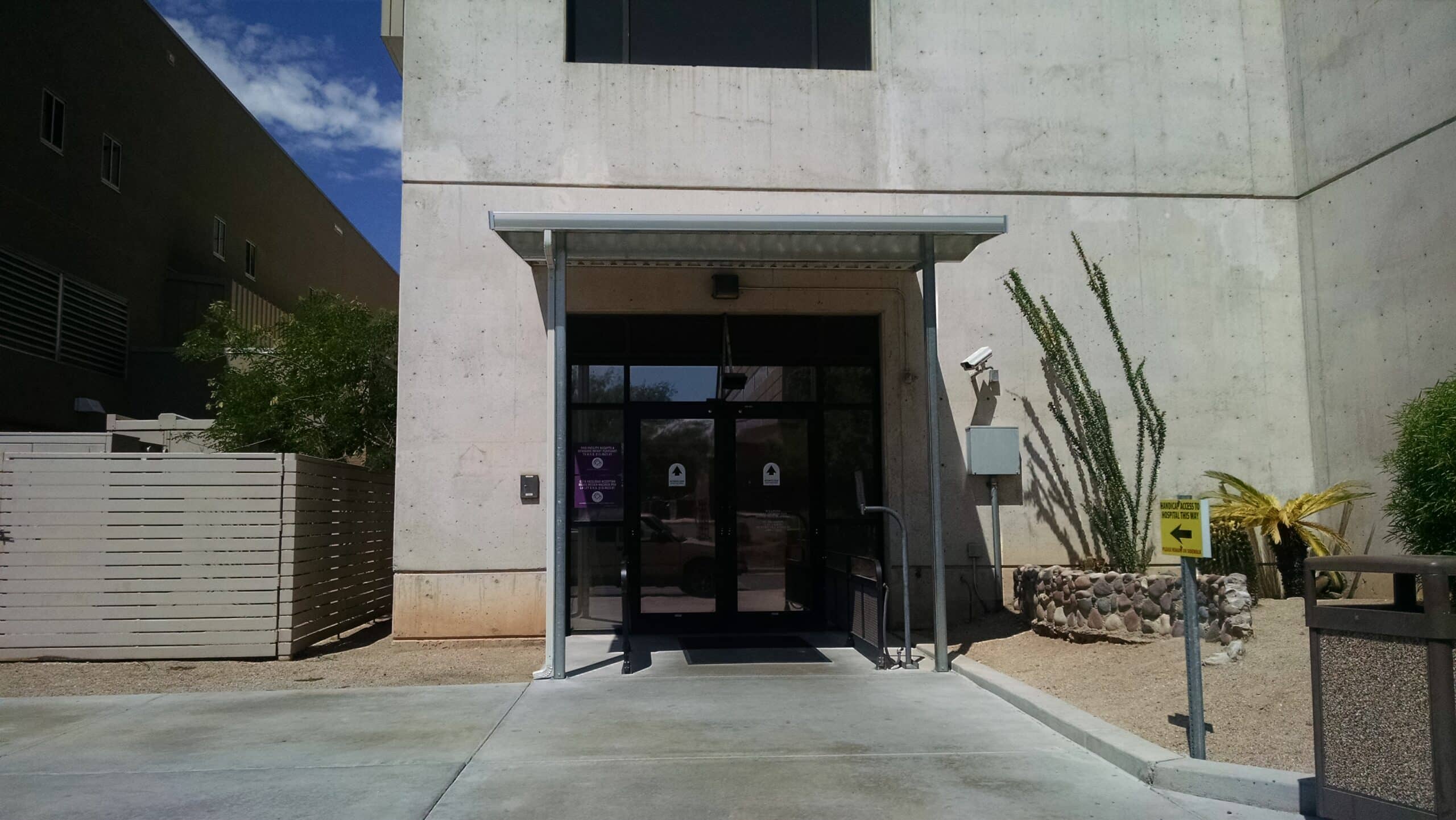 Small aluminum awning installed over the entrance of a commercial office building in Tucson, AZ